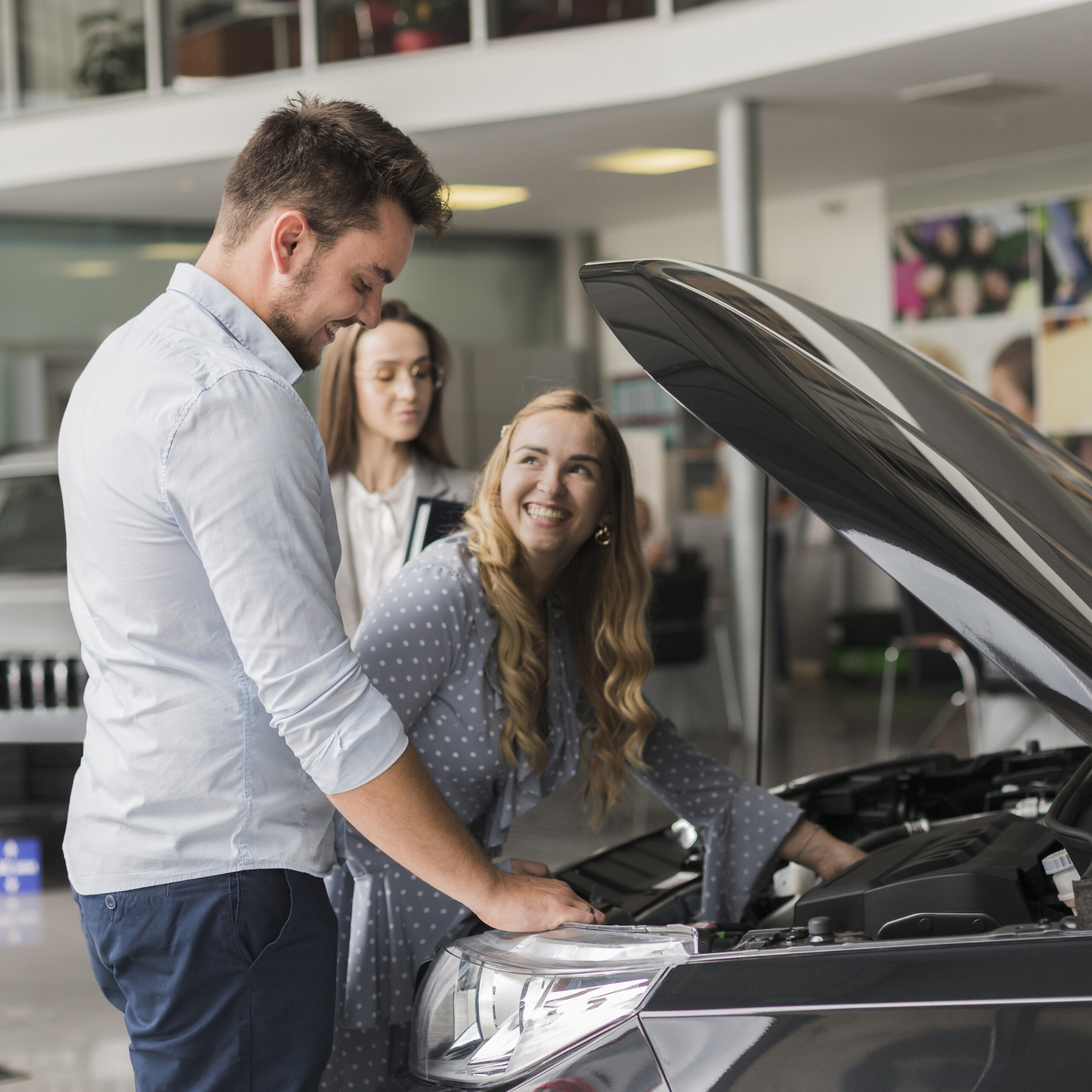 smiling-woman-checking-car-engine