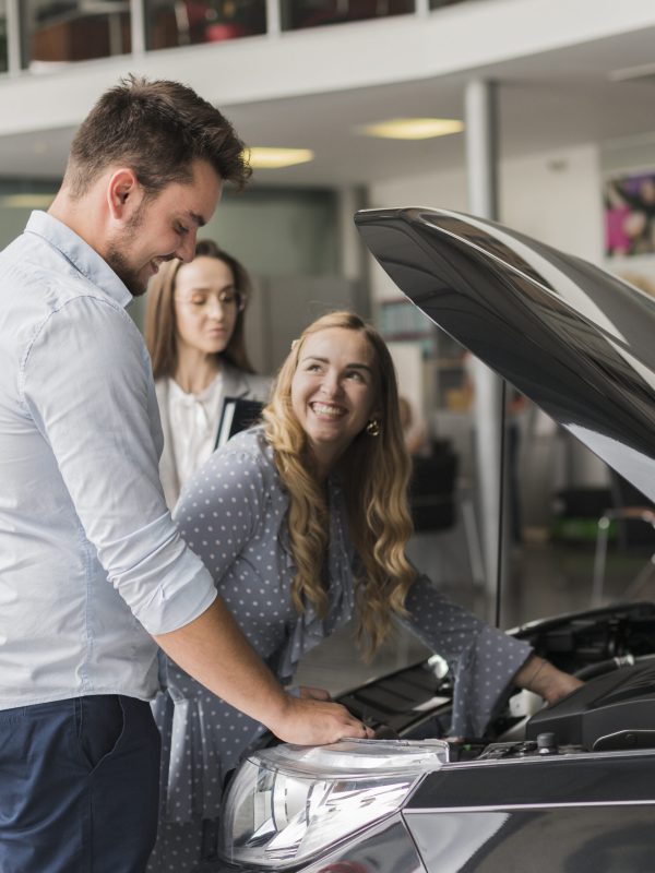 smiling-woman-checking-car-engine